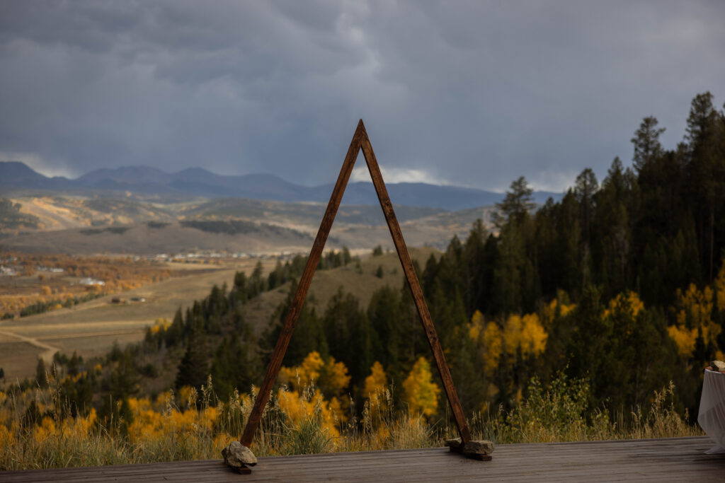 a wedding arch overlooking a mountain view in colorado in the fall