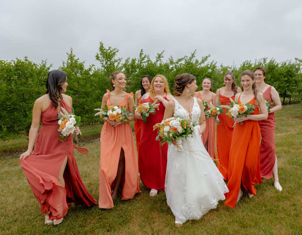 wedding bride with bridesmaids laughing and walking